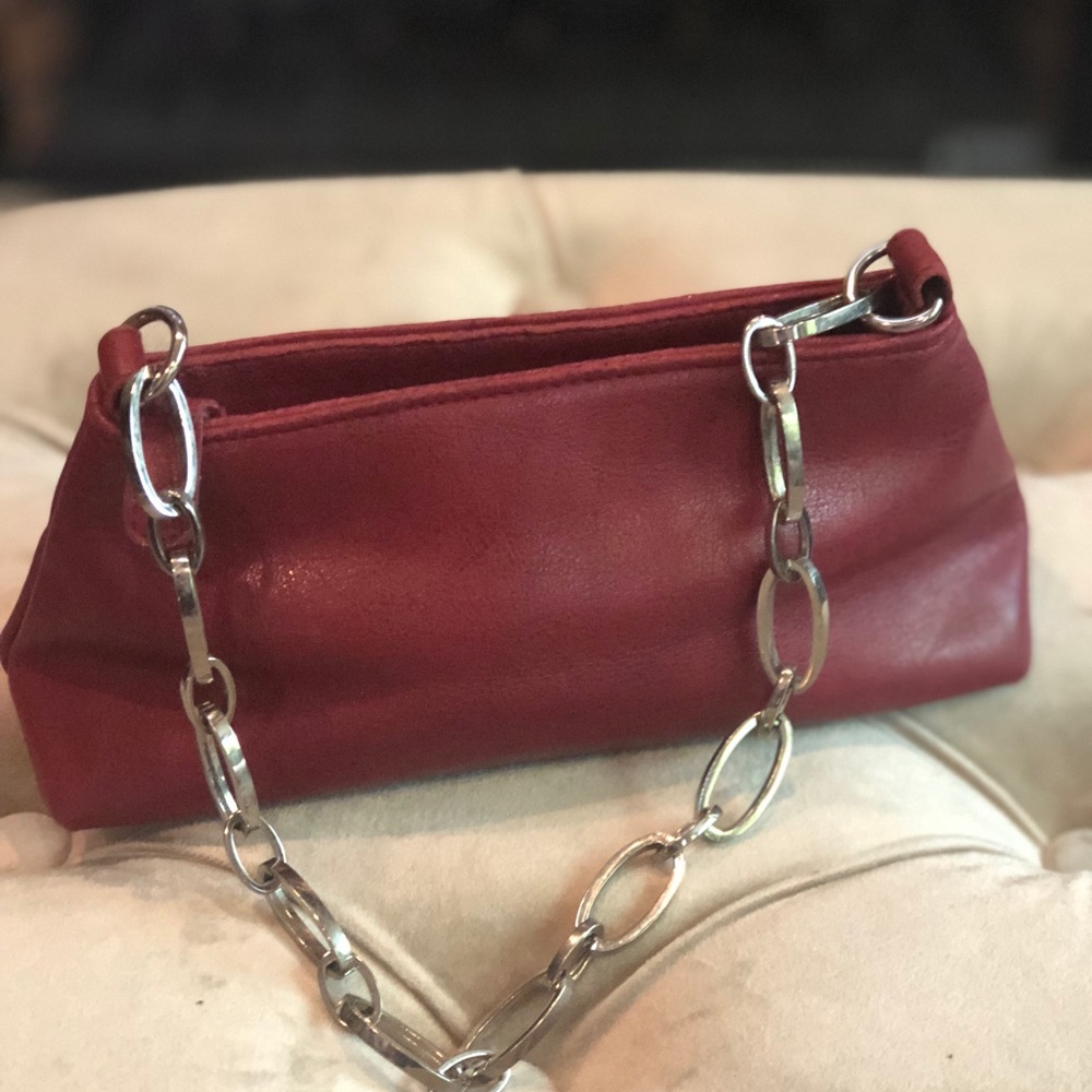 Red leather purse with silver chain strap.